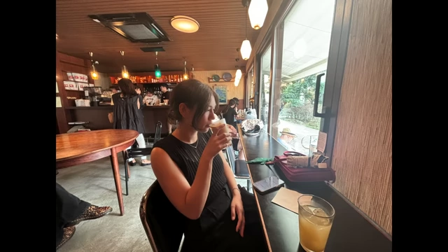 Speaker wearing the Uniqlo tank top in a cafe in Japan