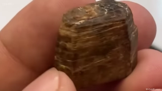 Thorium rock being held