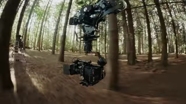 The cable cam with camera providing an overhead tracking shot of the horse.