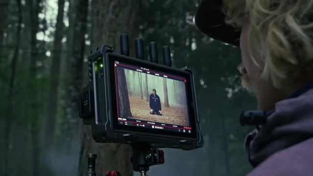 The DJI high-bright monitor displaying real-time footage from the camera.