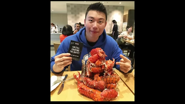 Max showcasing a massive plate of lobster at a buffet, illustrating his past habit of overeating until sick