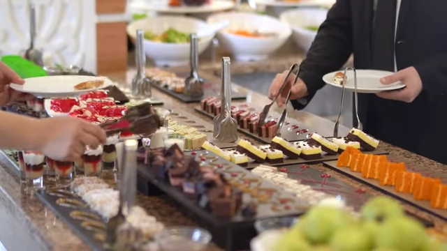 A dessert buffet spread, symbolizing the variety of new tastes that trigger the brain's reward system and lead to overeating