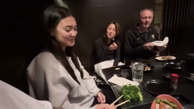 Isabel at a restaurant with friends, eating only broccoli, highlighting the social 'FOMO' experienced during the diet