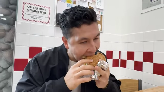 The speaker enjoying a burger during a planned 'treat meal' (hedonic deviation), demonstrating an allowed break from the strict diet