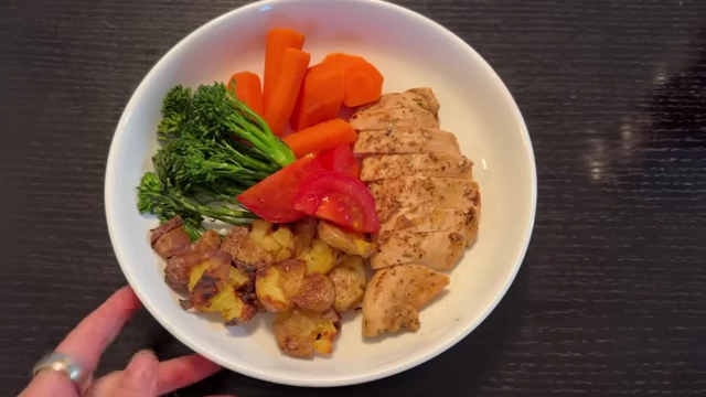 Isabel's diversified meal featuring chicken, potatoes, carrots, broccoli, and tomato, reflecting her increased flexibility