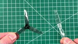 The kit includes both a tri-blade prop (left) and a bi-blade prop (right) for comparison.