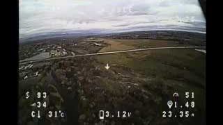 The FPV feed shows the drone's OSD during the first long-range test, displaying a distance of 1.48km and current voltage.