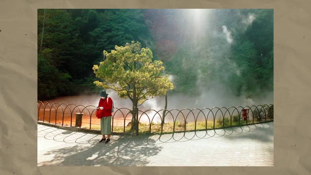 Teo Crawford's grandma standing near a bubbling hot spring in Beppu, with sunlight filtering through the steam