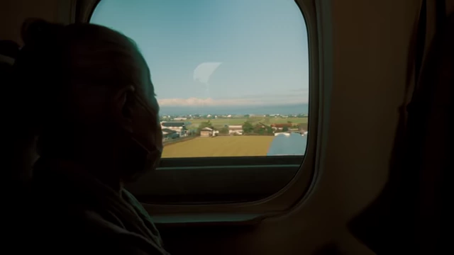 Teo Crawford and his grandma on a train in Japan, traveling through the countryside