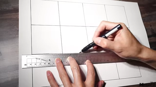 Artist drawing grid lines on paper