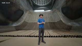 A SpaceX engineer standing inside the Starship flame trench, providing a sense of scale for the massive structure.