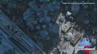 Aerial view of Pad 1 construction, showing the excavated trench and exposed foundation piles.