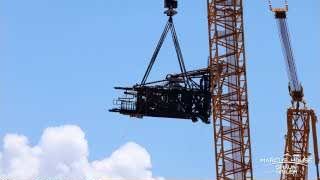 The Ship Quick Disconnect extension being lowered after removal for modification.