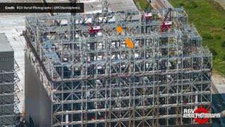 A closer aerial view of the Gigabay structure, showing the final seventh level under construction with tower cranes.
