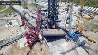 The massive 1,800-metric-ton launch bridge being recovered from the flame trench by cranes.