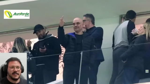 Alexandre de Moraes showing his middle finger at a football game.
