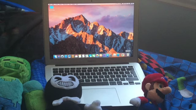 The friends transformed into plush toys (Zombie, Bendy, Mario) and a MacBook in a real-world setting.