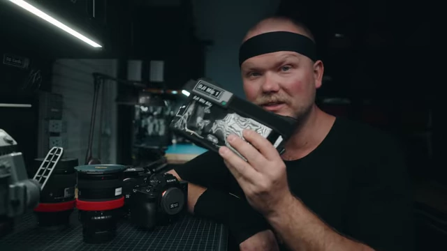 The speaker holds up the DJI Mic version 1, highlighting it as an affordable audio solution.