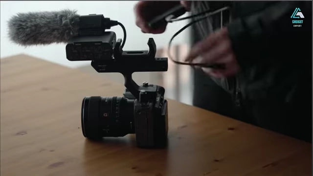 The FX3 II with its XLR-K3M top handle, microphone, and external SSD attached, illustrating its cageless design and accessory compatibility.