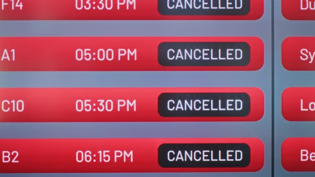 An airport display board showing multiple flights as "CANCELLED".