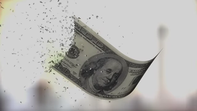 A hundred-dollar bill appearing to disintegrate into small pieces, symbolizing economic loss.