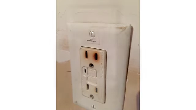 Burnt electrical outlet from improper installation.