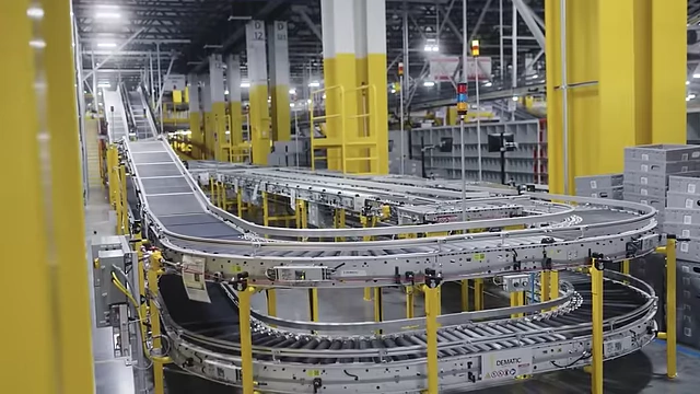 A conveyor belt system in an Amazon warehouse, symbolizing long-term logistical investment