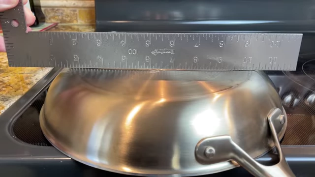 Measuring the flatness of the pan with a ruler to detect warping.
