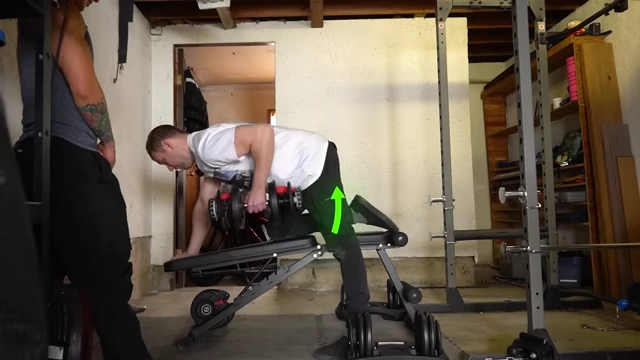 Dayton executing a single-arm dumbbell row, sweeping arm towards hips for lat width.