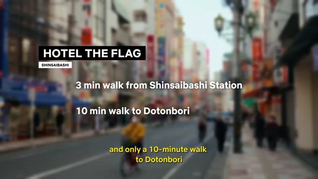 Text overlay on a blurred street scene indicates that Hotel The Flag in Shinsaibashi is a 3-minute walk from Shinsaibashi Station and a 10-minute walk to Dotonbori.