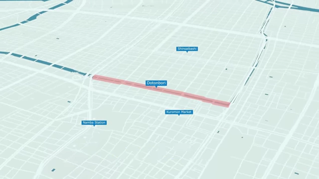 A map of Osaka highlighting the Dotonbori area in pink, showing its proximity to Namba Station, Shinsaibashi, and Kuromon Market.