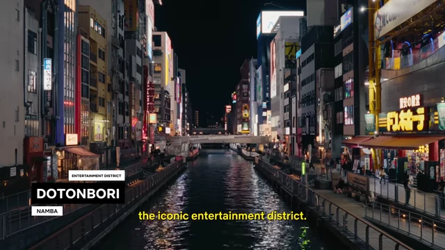 The vibrant Dotonbori canal at night, lined with neon-lit buildings and reflecting lights on the water.