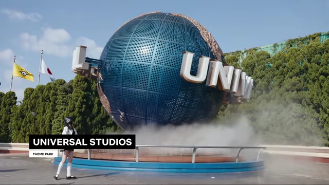 The iconic Universal Studios globe, with water mist rising from its base, at the entrance of Universal Studios Japan.