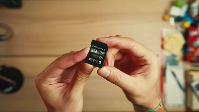 A ProGrade V90 256GB SD card being held