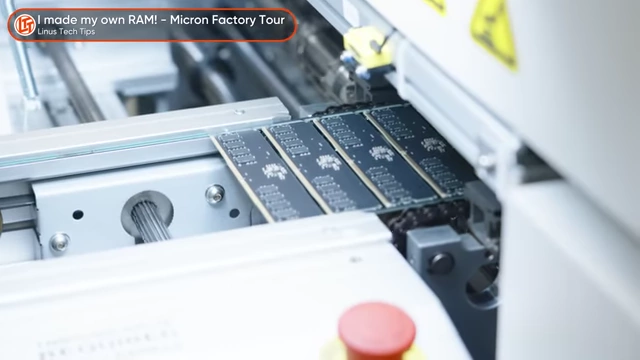 Close-up of automated machinery assembling RAM modules on a production line.
