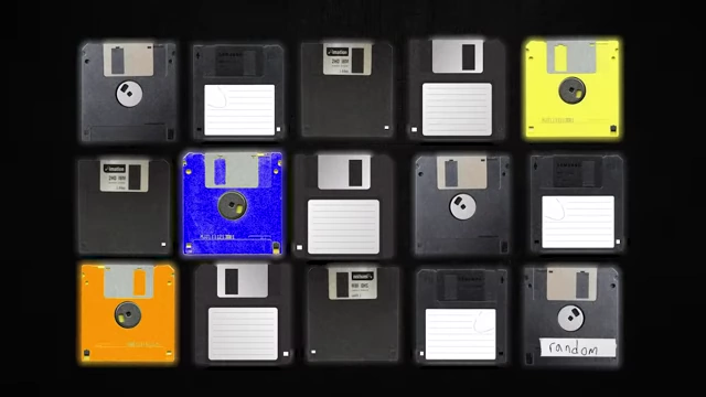 A collection of 15 floppy disks, representing the programs submitted for Axelrod's tournament, including one labeled "random"