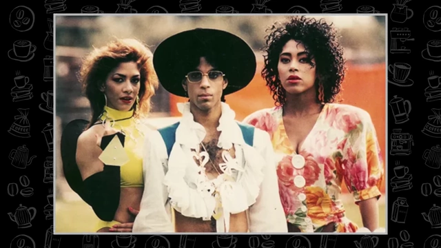 A photo of the musician Prince, who was known for his short stature. He is flanked by two women.