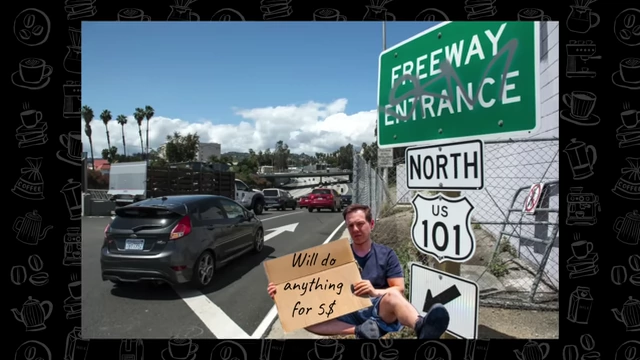 A man sitting on the ground holding a cardboard sign that reads "Will do anything for $$.", near a freeway entrance sign for US 101.
