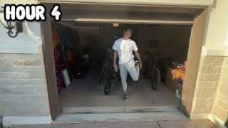 The presenter stretching his leg in a garage entrance, with the text "HOUR 4" overlaid.