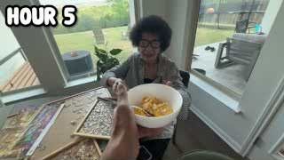 The presenter's grandmother eating scrambled eggs while the presenter holds the plate, with the text "HOUR 5" overlaid.