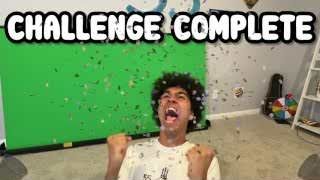 The presenter celebrating with confetti falling around him and the text "CHALLENGE COMPLETE" overlaid.