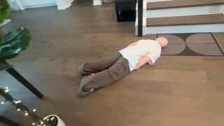 The presenter lying face down on the floor, implying total exhaustion after the challenge, as his mom returns home.