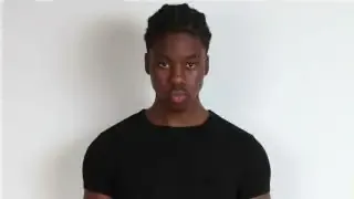 A model wearing a black t-shirt, emphasizing the silhouette.