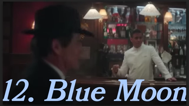 A man in a hat is seated at a bar in "Blue Moon."