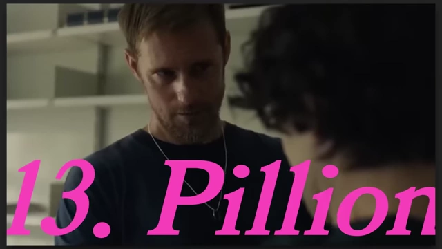 A man with dark curly hair looks at someone intently in "Pillion."