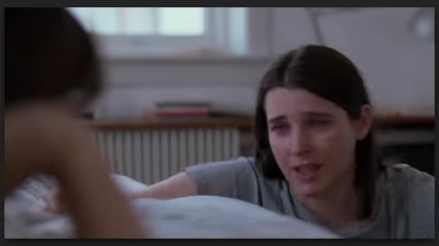A woman with tears in her eyes, conveying emotional depth in "Sentimental Value."