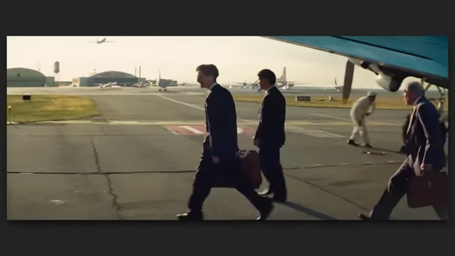 Three men in suits walking away from an airplane on an airfield, conveying the grand scale and international scope of "Marty Supreme."