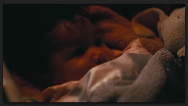 A close-up of a sleeping baby, representing the theme of fatherhood in "One Battle After Another."