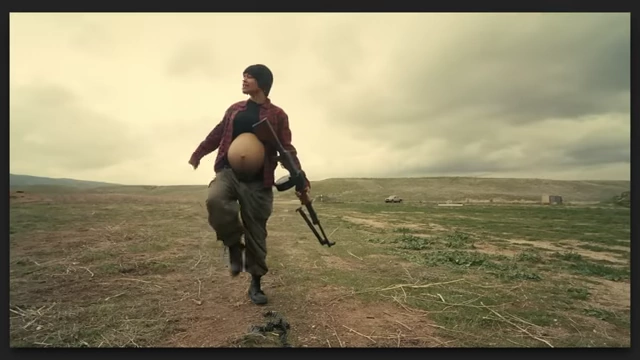 A pregnant woman in a field holding a rifle, a powerful visual reflecting themes of revolution and the new world in "One Battle After Another."