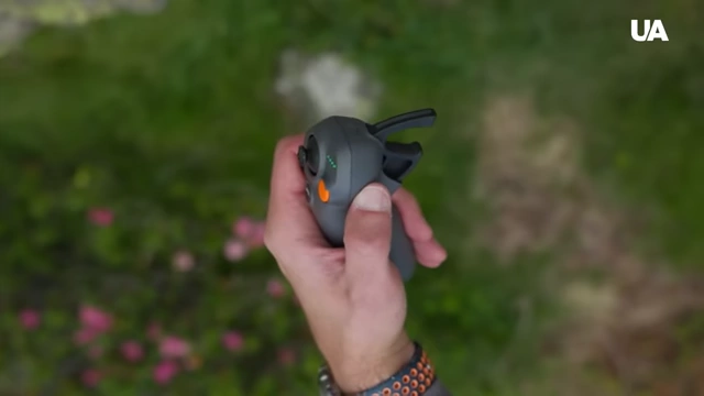 A hand holding a drone controller